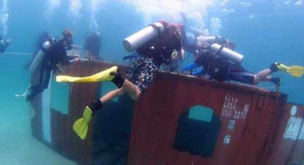 Divers-place-coral-on-a-shipping-container-off-Koh-Rong-Samloem